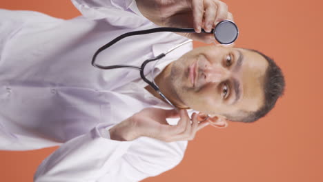 Vertical-video-of-Doctor-listening-to-camera-with-stethoscope.